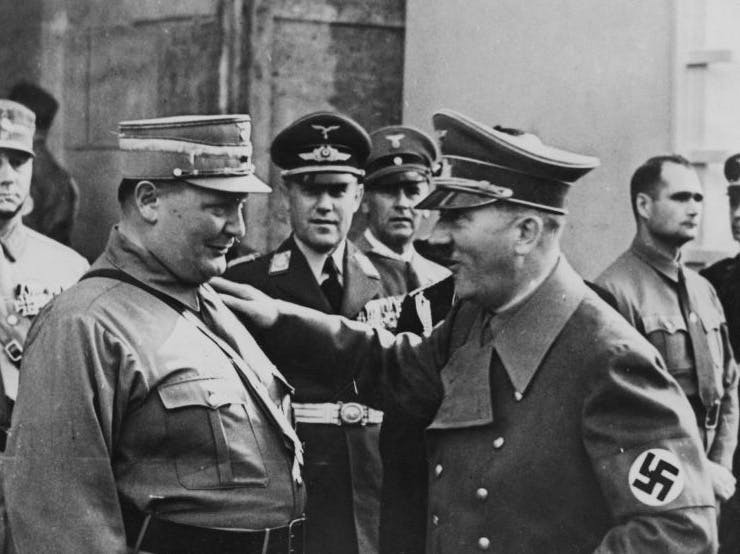 German Chancellor Adolf Hitler (1889 - 1945) gives Hermann Goering (1893 - 1946), President of the Reichstag, a friendly pat on the shoulder during a view of troops at Luitpold Arena in Nuremberg, Germany, 11th September 1938. Rudolf Hess can be seen on the right. (Photo by Keystone/Hulton Archive/Getty Images)