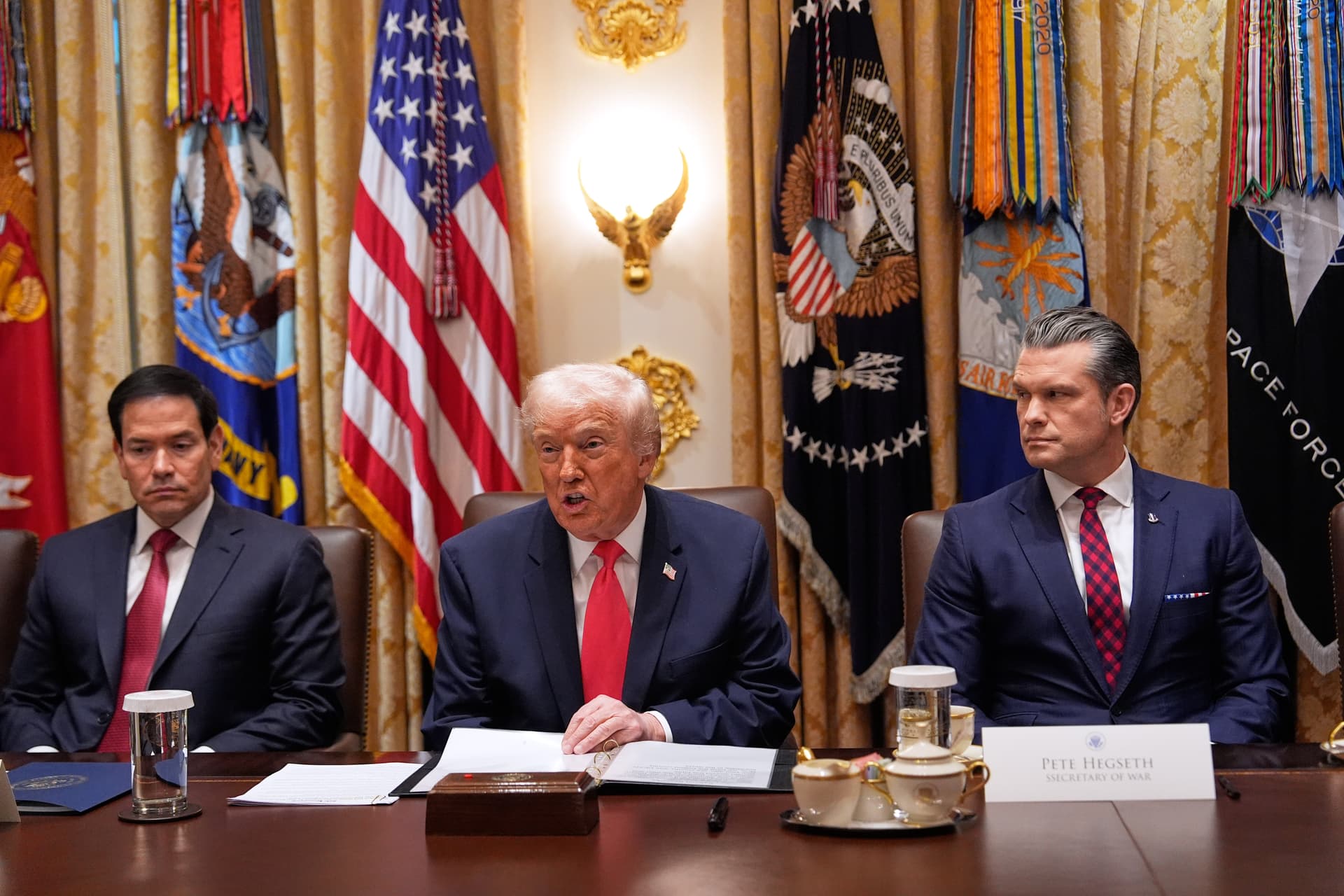 AP/Julia Demaree Nikhinson President Trump at a Cabinet meeting at the White House, December 2, 2025, flanked by Secretary of State Marco Rubio, left, and Defense Secretary Pete Hegseth, right.