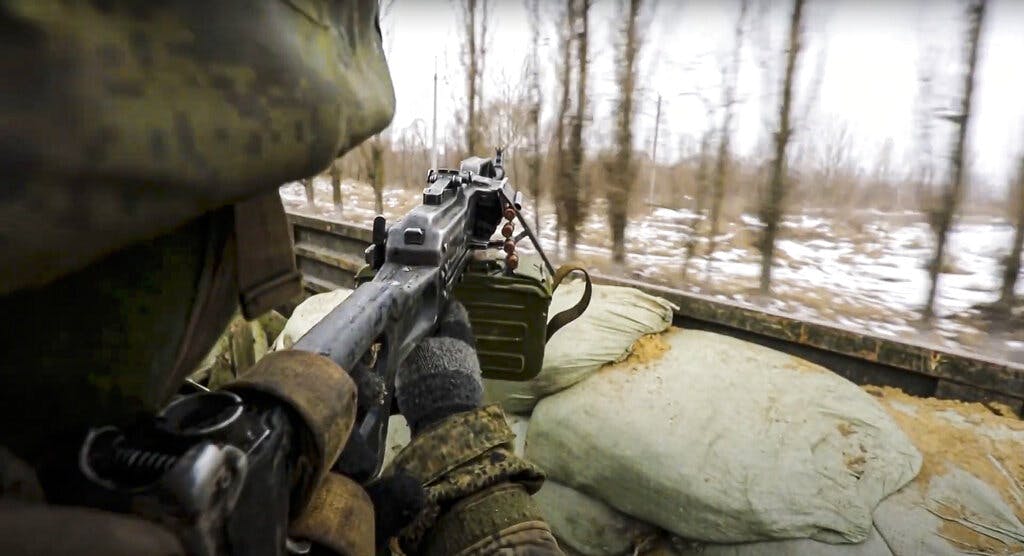 A Russian soldier points a gun from a Russian military truck as it drives through an undisclosed location in Ukraine. Photo taken from video released by the Russian Defense Ministry Press Service March 3, 2022, via AP