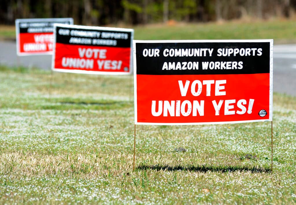 Signs supporting the Retail, Wholesale and Department Store Union near the Amazon fulfillment center at Bessemer. 