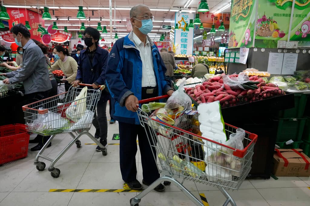 Residents stock up at a supermarket at the Chaoyang district of Beijing on Monday. AP Photo/Ng Han Guan