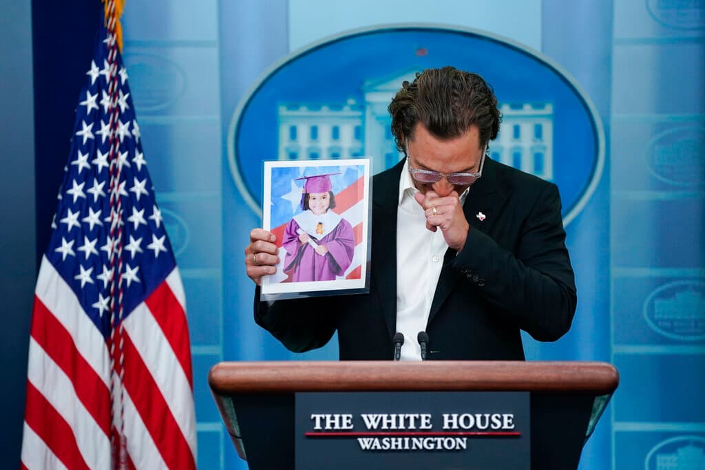 Actor Matthew McConaughey holds an image of Alithia Ramirez, 10, who was killed in the mass shooting at Uvalde, Texas, as he speaks at the White House, June 7, 2022. 