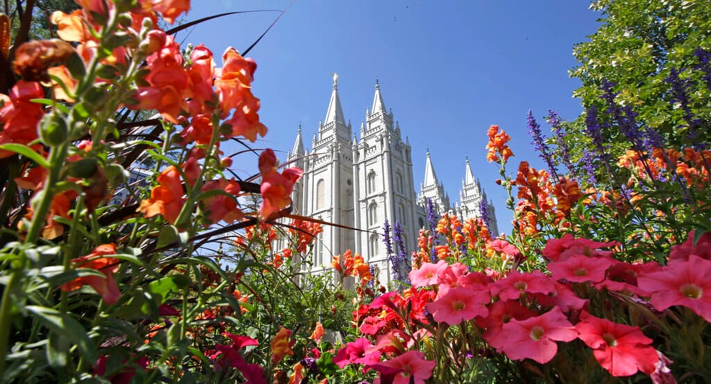 Flowers bloom in front of the Mormon Salt Lake Temple, at Salt Lake City.