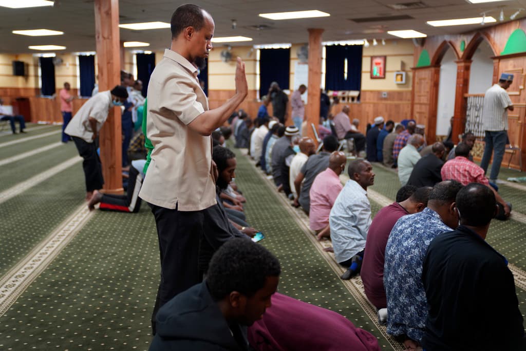 The director of the Islamic Association of North America, Yusuf Abdulle, standing, with other Muslims praying at the Abubakar As-Saddique Islamic Center at Minneapolis in 2022. 