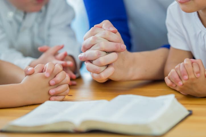 Children praying in school.