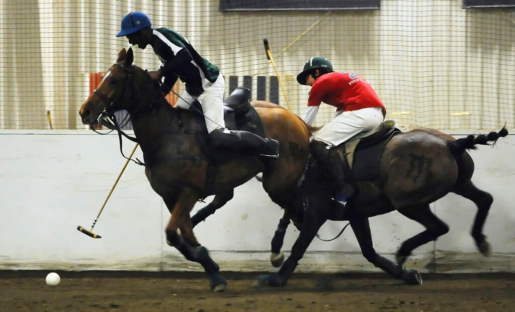 Colorado State's Kareem Rosser, left, is pursued by Southern Methodist University's Manuel Huarte during a polo match at the University of Connecticut, April 8, 2015.