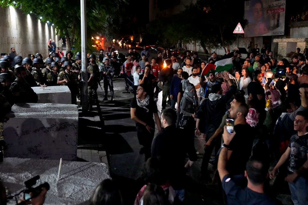 Demonstrators throw stones towards the French embassy during a protest in solidarity with the Palestinian people at Beirut, Lebanon.