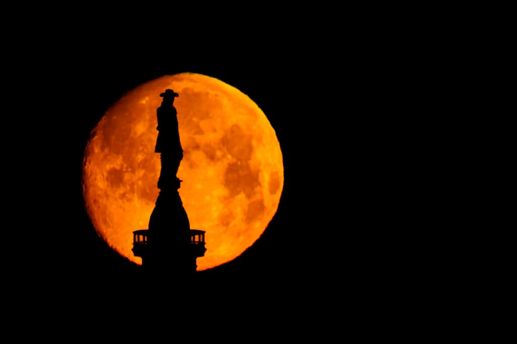 The moon sets behind a statue of William Penn atop of City Hall at Philadelphia. A similar statue of Penn in a nearby park will be removed to make room for more 'inclusive' displays.