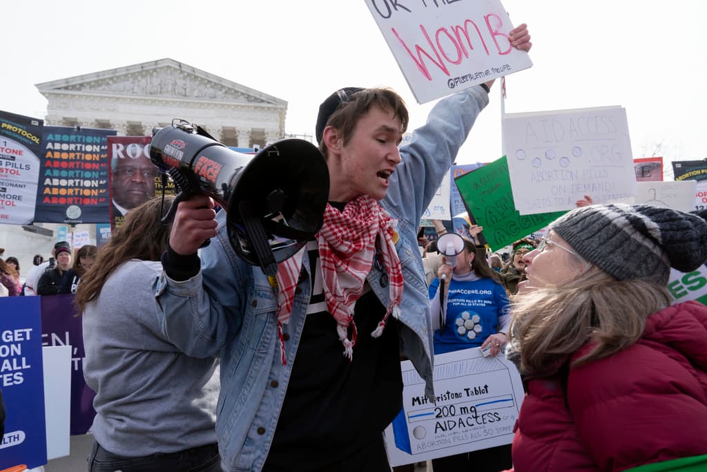 Anti-abortion and abortion-rights activists rally outside the Supreme Court, March 26, 2024, at Washington.