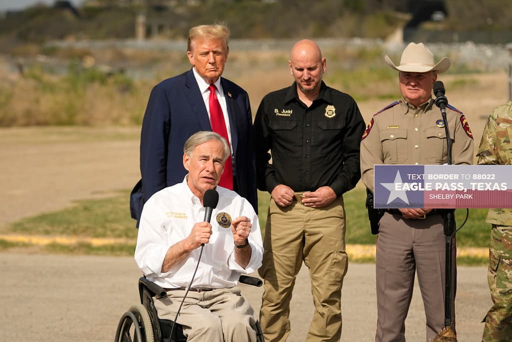 President Trump listens as Governor Greg Abbott speaks during a visit to the Mexican border on February 29, 2024 at Eagle Pass, Texas.