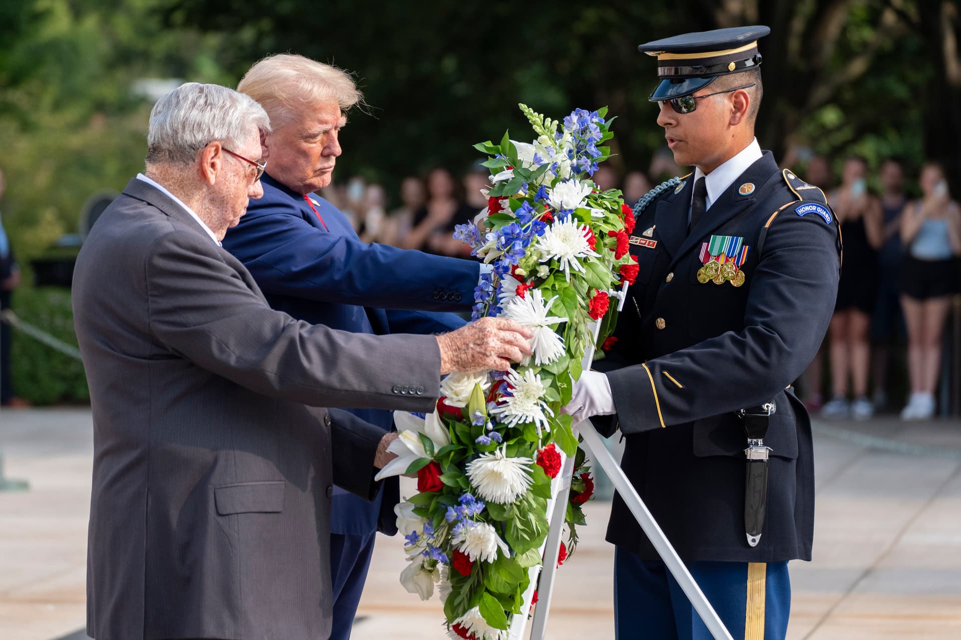 Bill Barnett, left, grandfather of Darin Taylor Hoover, and President Trump place a wreath at the Tomb of the Unknown Solider at Arlington National Cemetery.