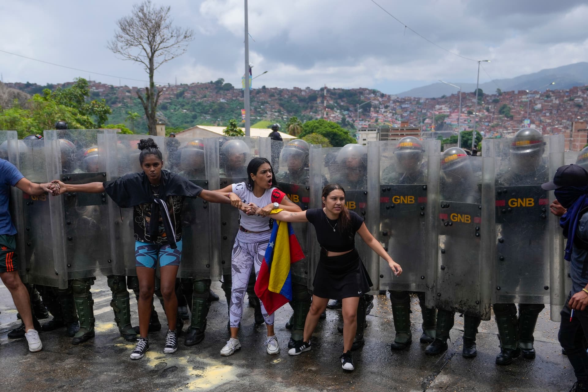 Residents try to block a street to protest the official results the day after the presidential election in Venezuela.