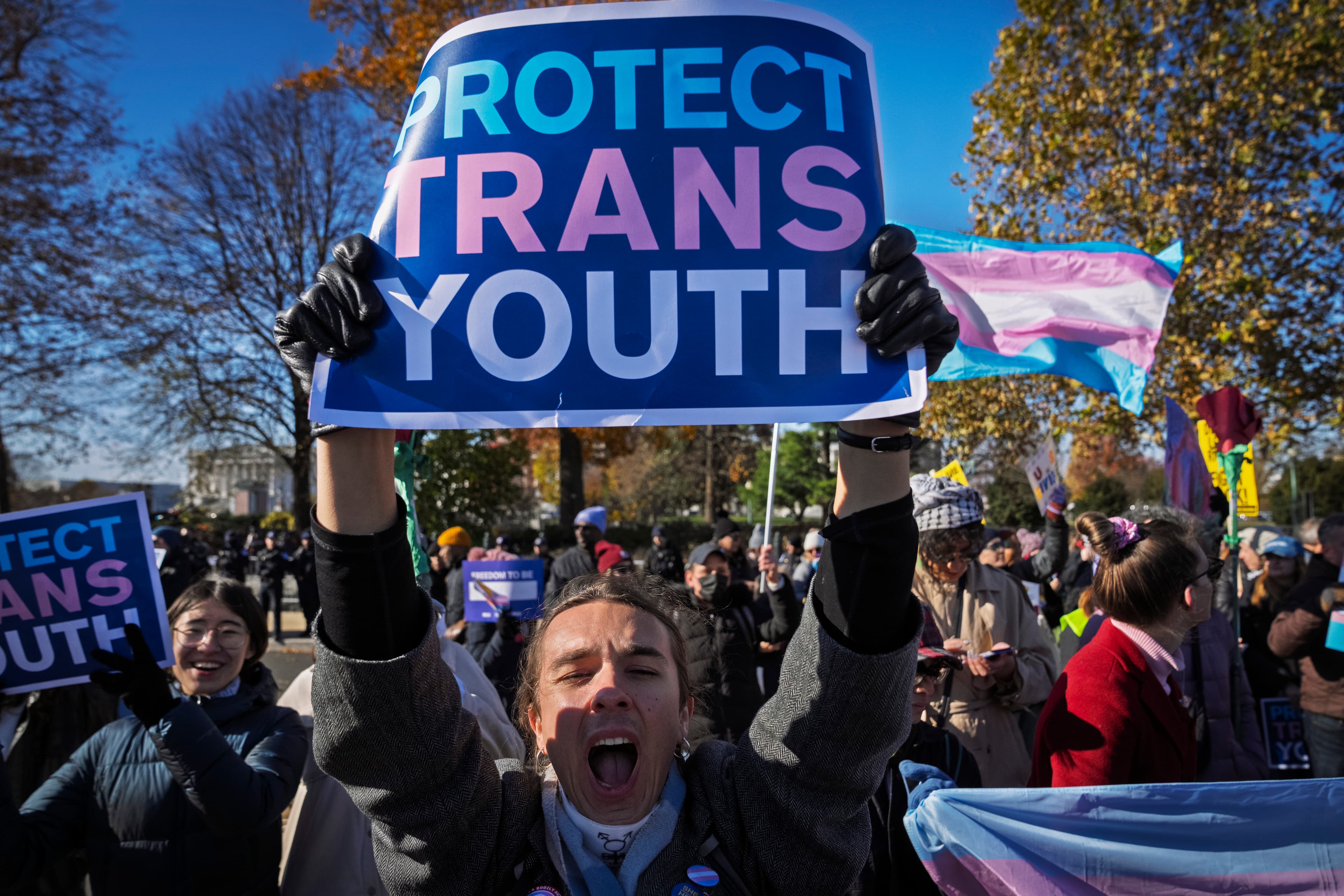 A young person cheers as supporters of transgender rights rally by the Supreme Court, December 4, 2024.