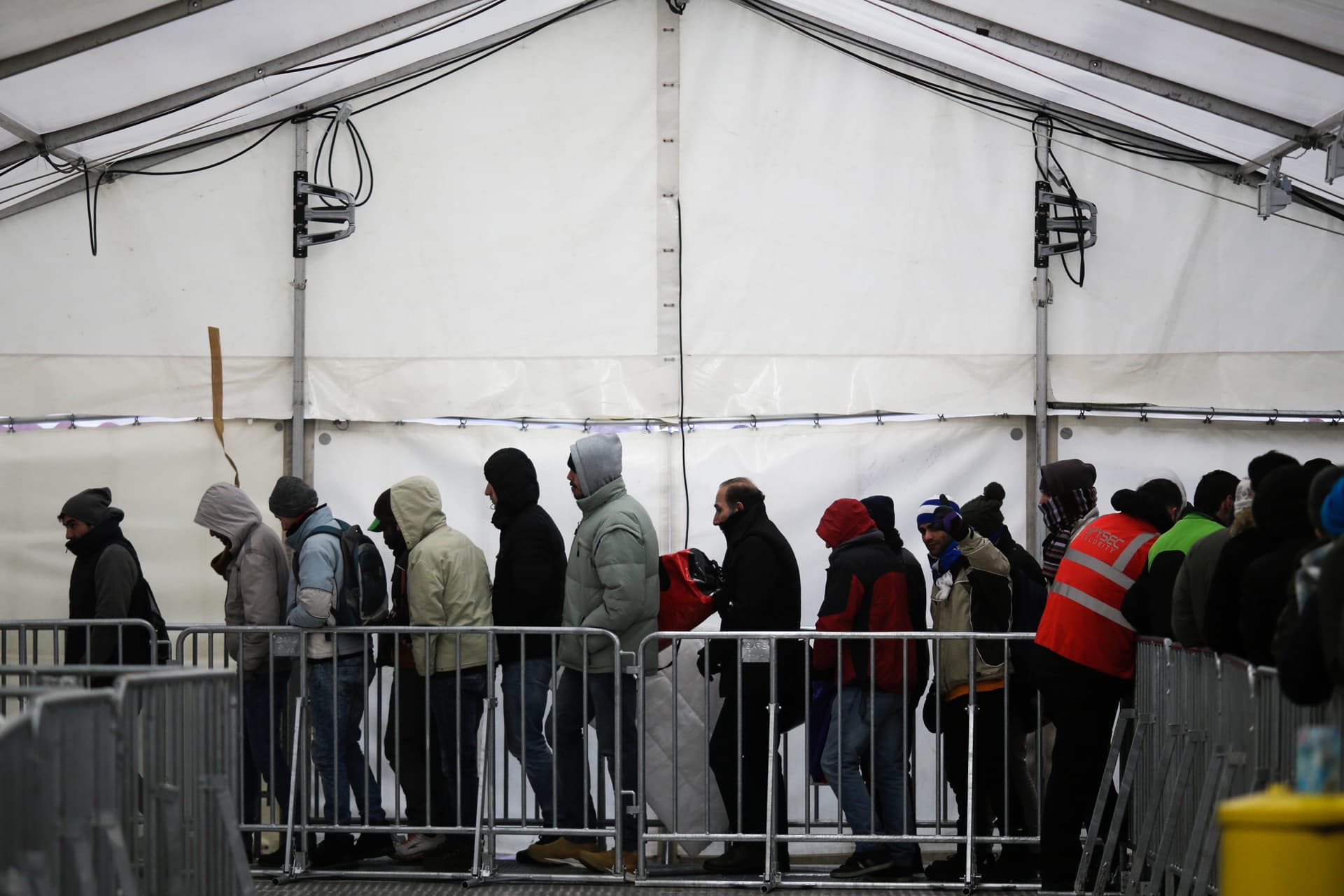 Migrants and refugees line up at the central registration center for refugees and asylum seekers at Berlin, Germany.