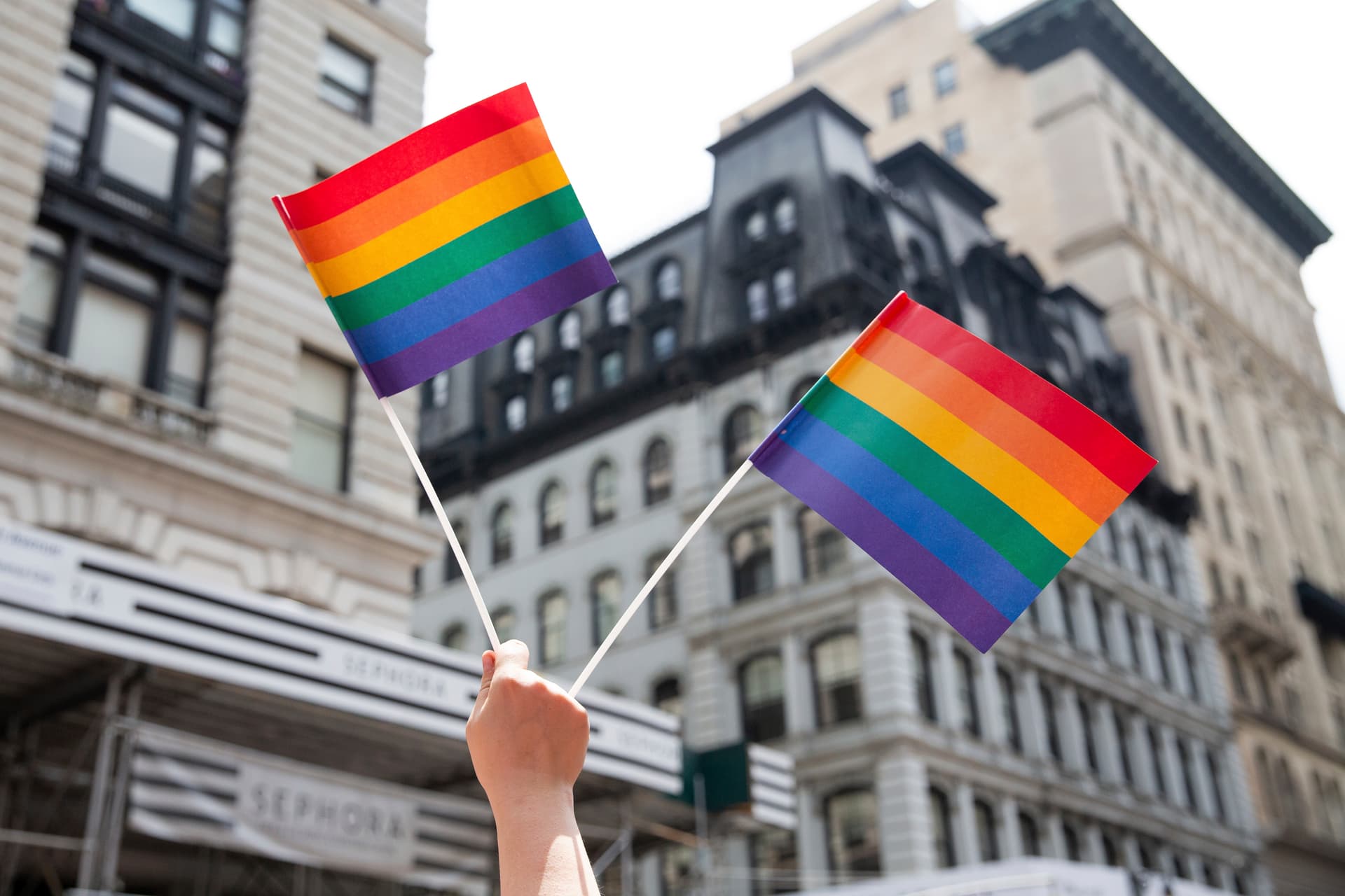 A person holds up LGTBQ+ pride flags during the Pride Parade at New York.