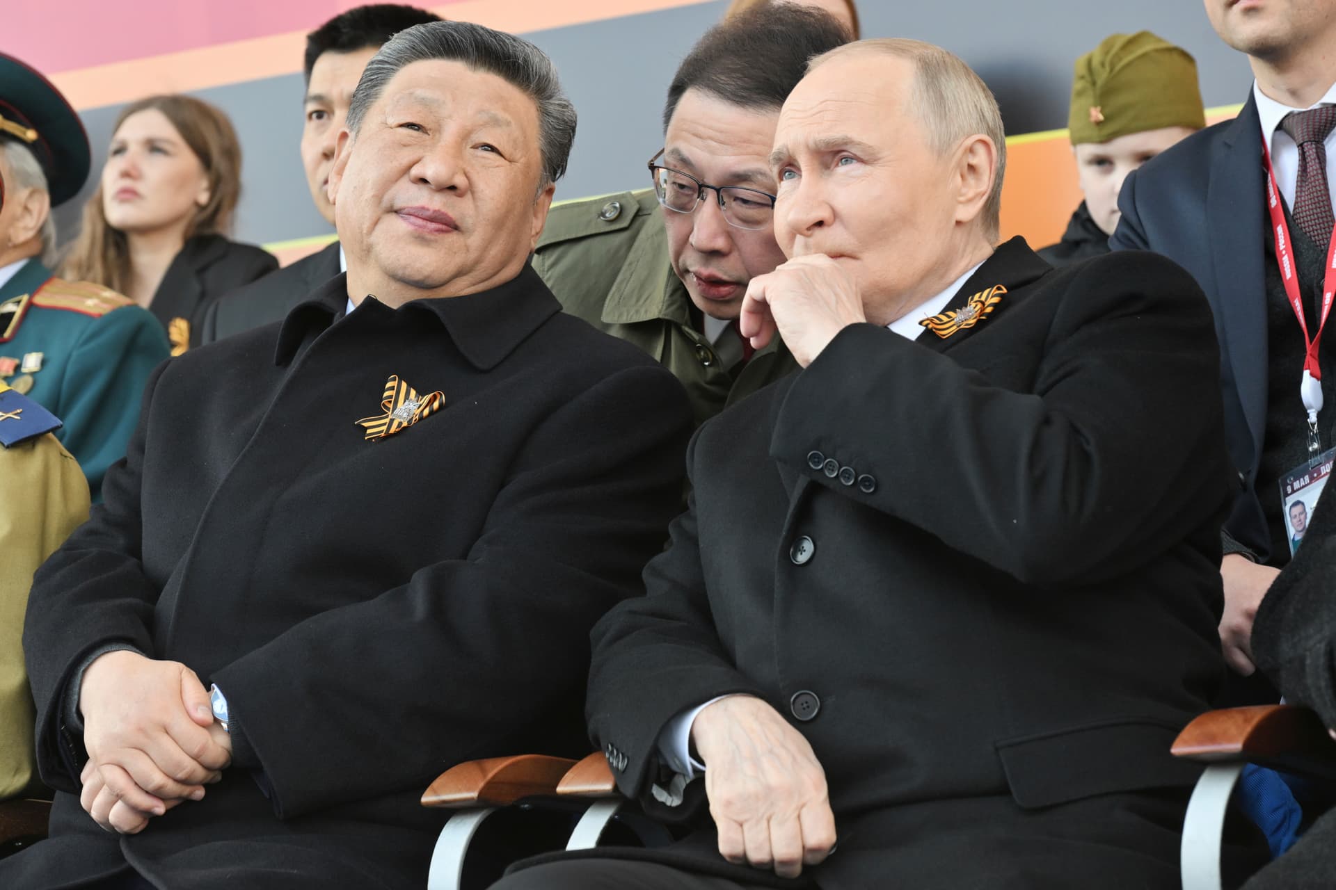 Presidents Vladimir Putin, right, and Xi Jinping, left, watch the Victory Day military parade at Moscow, May 9, 2025.