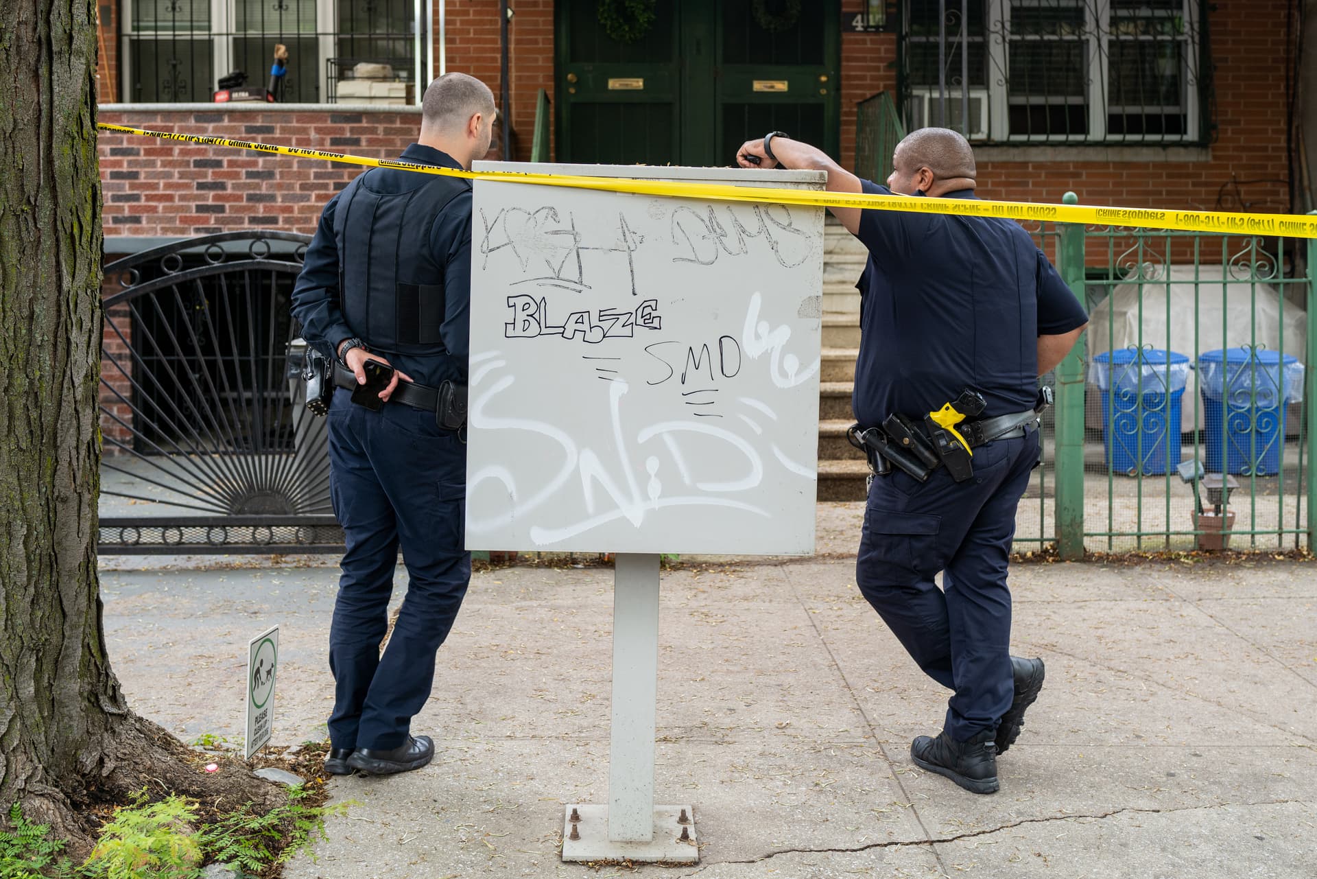 Police gather at the scene of a shooting in Brooklyn.