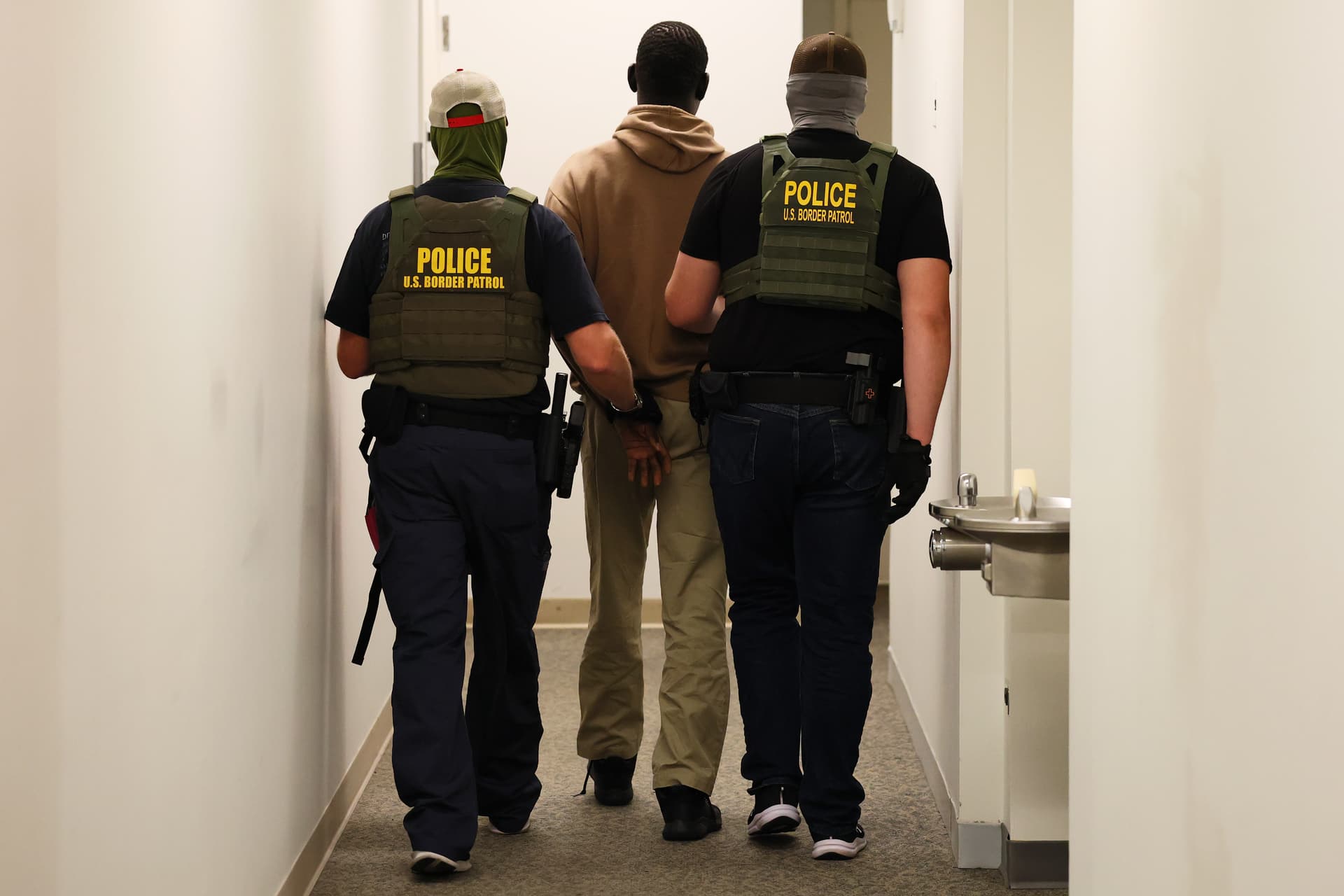 Federal agents detain a man after his court hearing in immigration court at the Ted Weiss Federal Building on July 09, 2025 in New York City.  