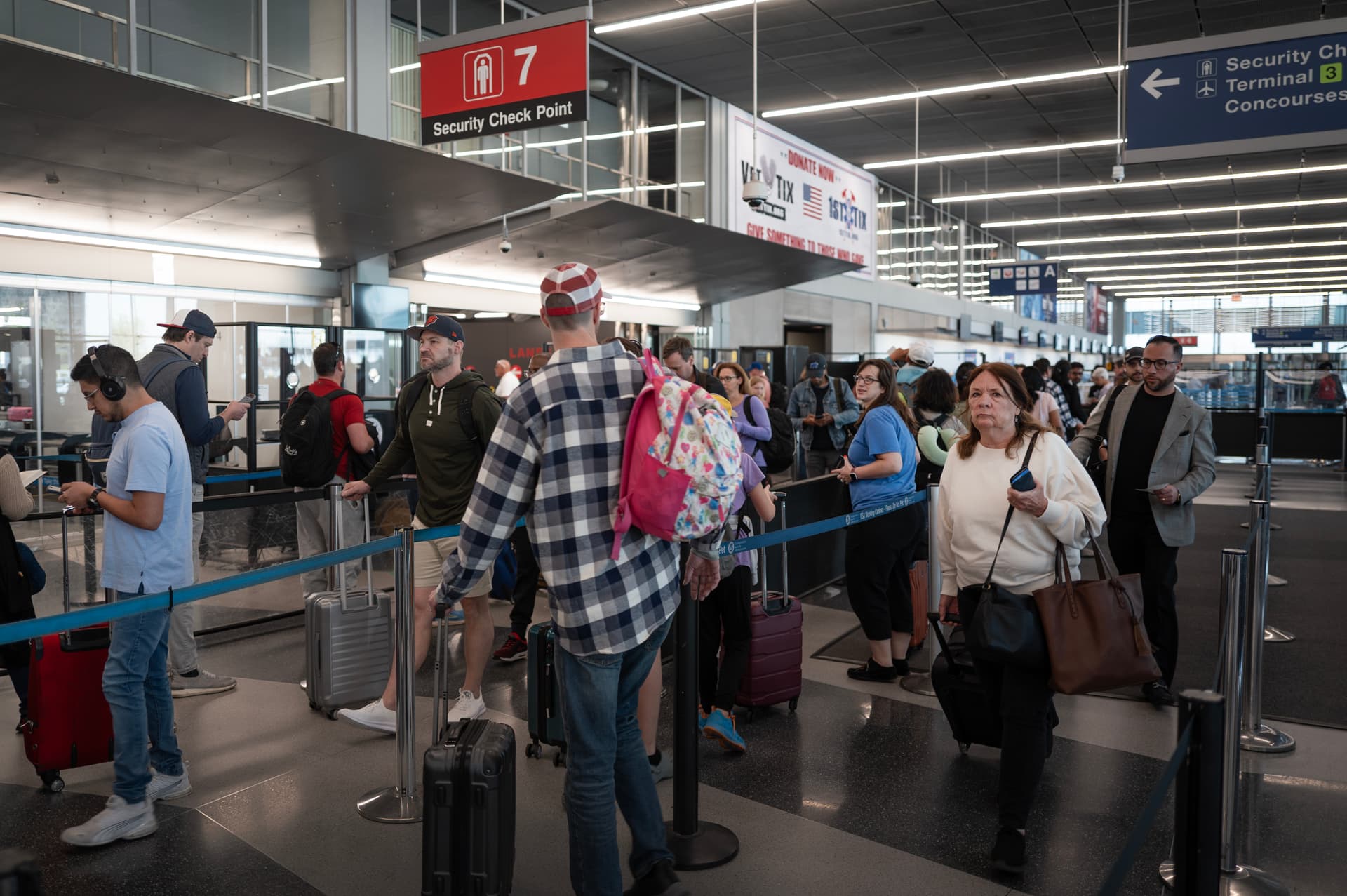 Passengers go through a security checkpoint at O'Hare International Airport.