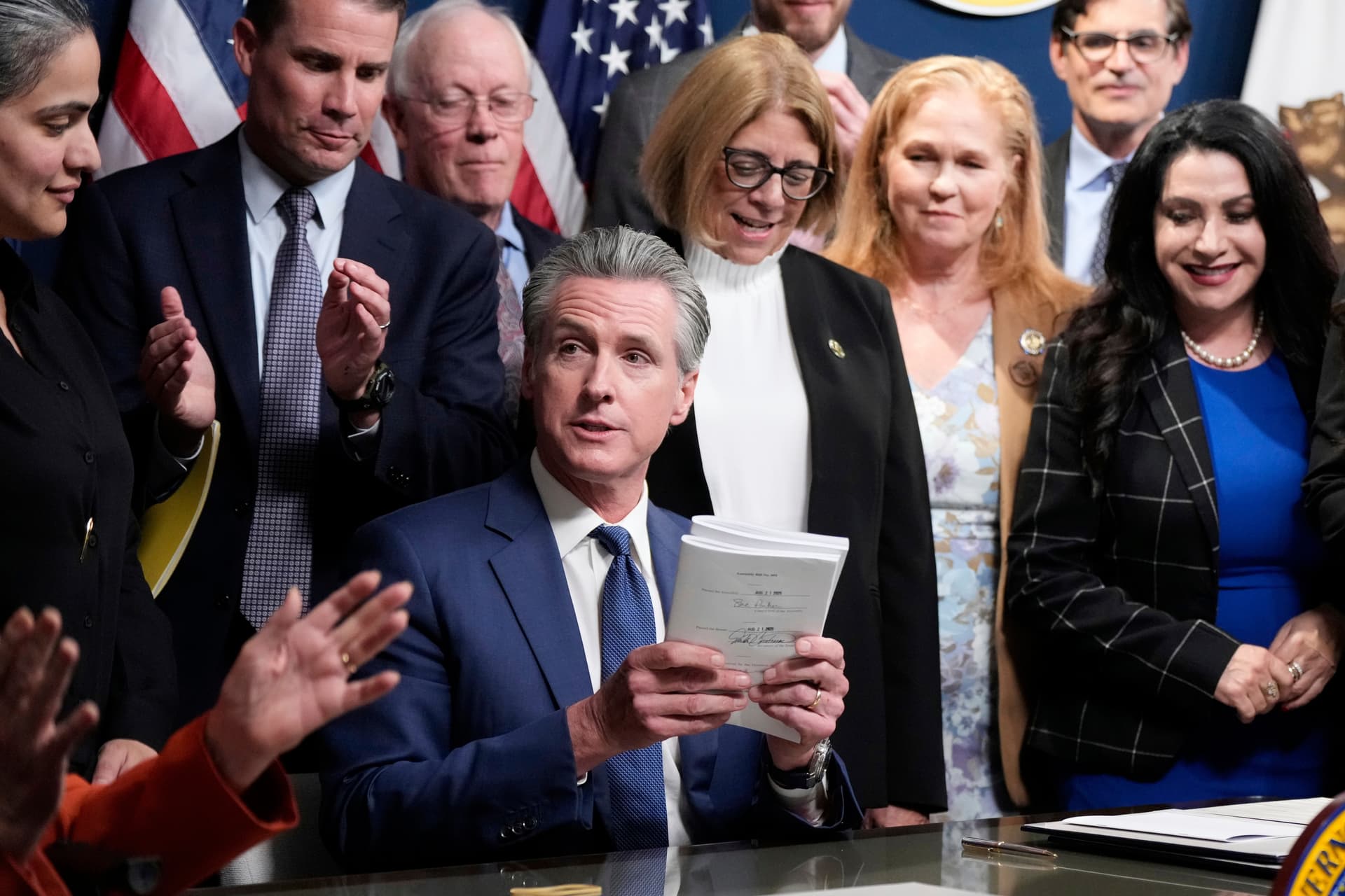 Governor Gavin Newsom of California signs legislation calling for a special election on a redrawn congressional map at Sacramento on August 21, 2025.