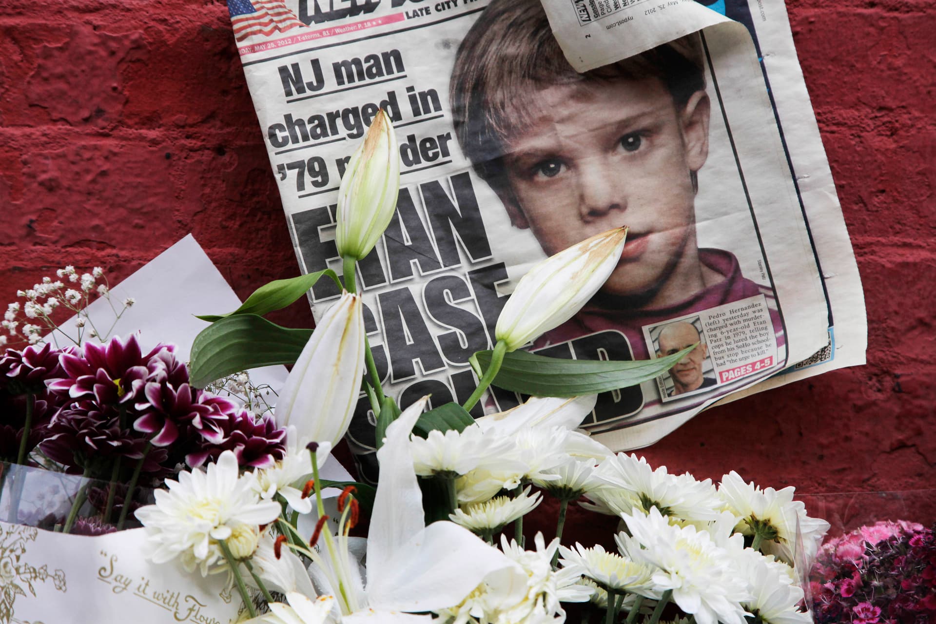 A makeshift memorial in 2012 featuring a newspaper with a photograph of Etan Patz in the SoHo neighborhood of New York, where the child lived before his disappearance in 1979. 