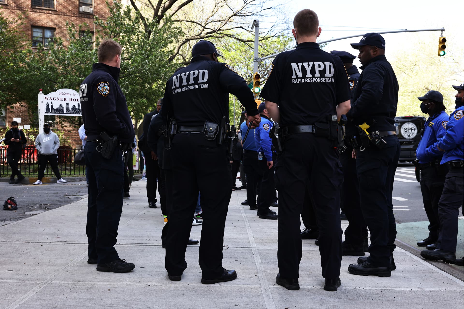 NYPD officers await the start of a peace walk to denounce gun violence in the city.