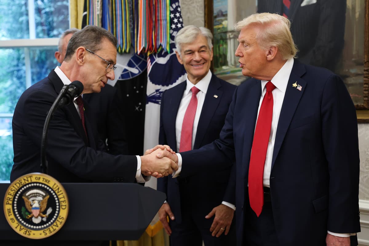 President Trump shakes hands with Pfizer CEO Albert Bourla (L) as he announces a deal with Pfizer to lower Medicaid drug prices in the Oval Office of the White House on September 30, 2025 in Washington, DC. 