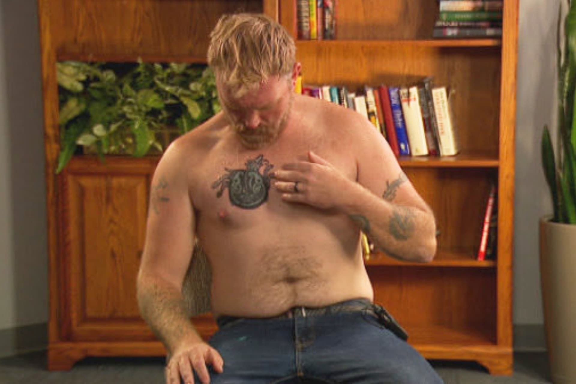 Candidate Graham Platner points to a covered up tattoo that had been recognized as a Nazi symbol during an interview iat Portland, Maine, on October 22, 2025. 
