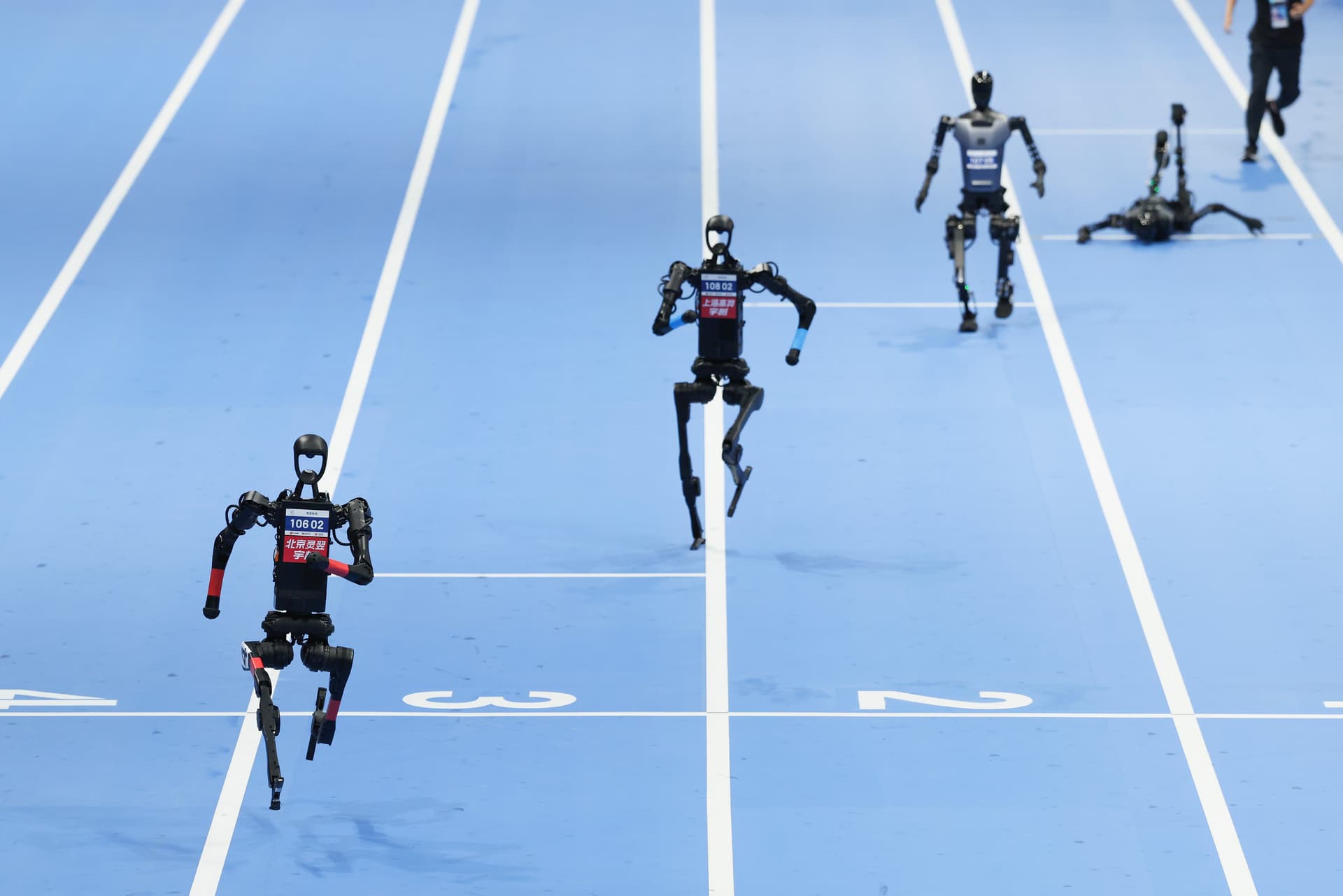 Humanoid robots compete in the 100m finals on day three of 2025 World Humanoid Robot Games at Beijing.