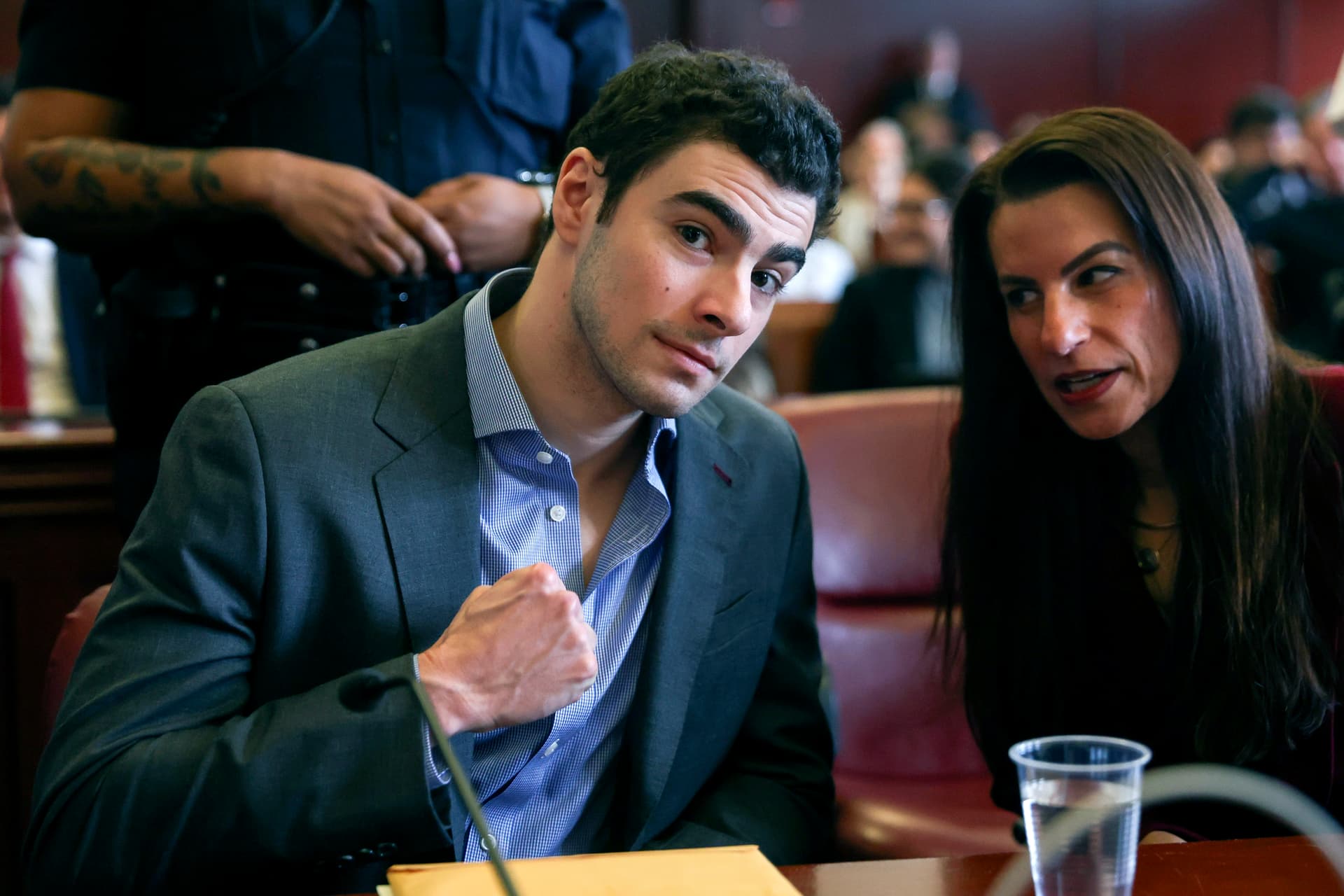 Luigi Mangione (L) appears with his lawyers for a suppression of evidence hearing in the killing of UnitedHealthcare CEO Brian Thompson in Manhattan Criminal Court on December 8, 2025.