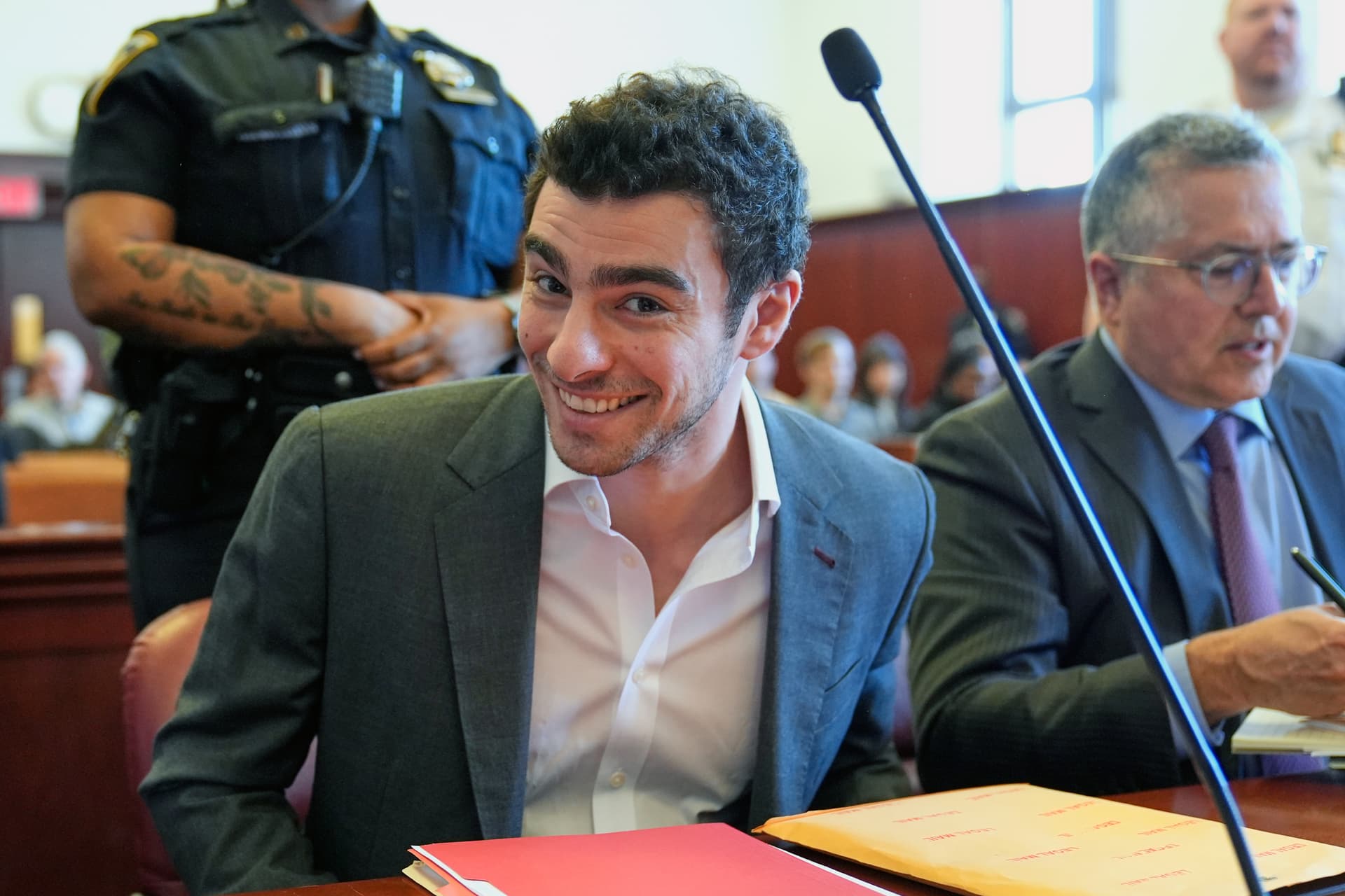 Luigi Mangione (L) sits next to his attorney, Marc Agnifilo (RO) as he appears for a suppression of evidence hearing in the killing of UnitedHealthcare CEO Brian Thompson in Manhattan Criminal Court on December 16, 2025.
