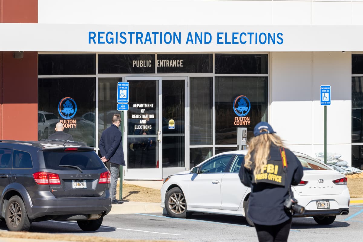 An FBI press office person approaches the Fulton County Election Hub and Operation Center on January 28, 2026, at Union City, Ga. 