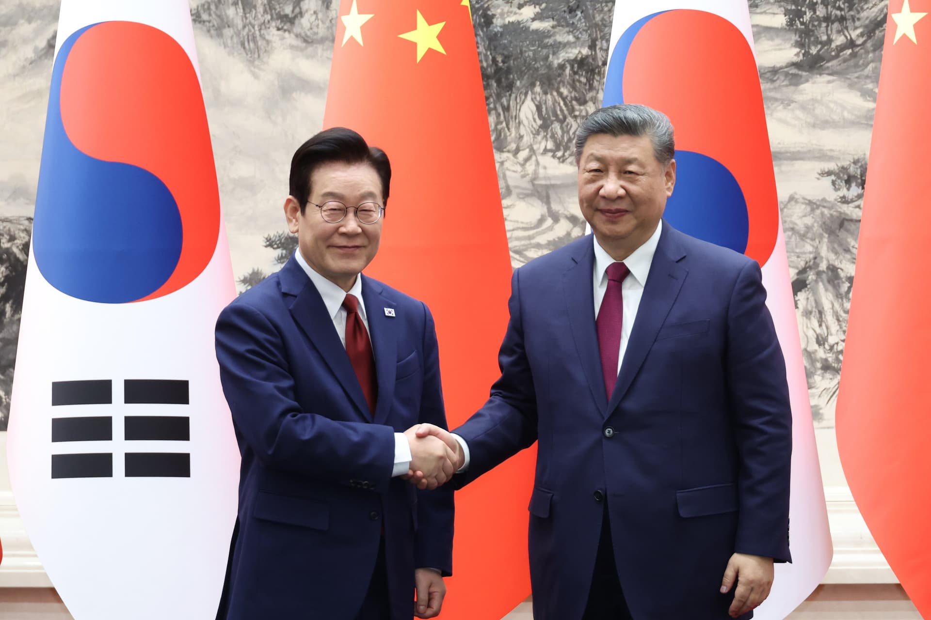 President Xi Jinping, right, shakes hands with South Korea's president, Lee Jae Myung, left, during a ceremony of the Memorandum of Understanding between South Korea and China.