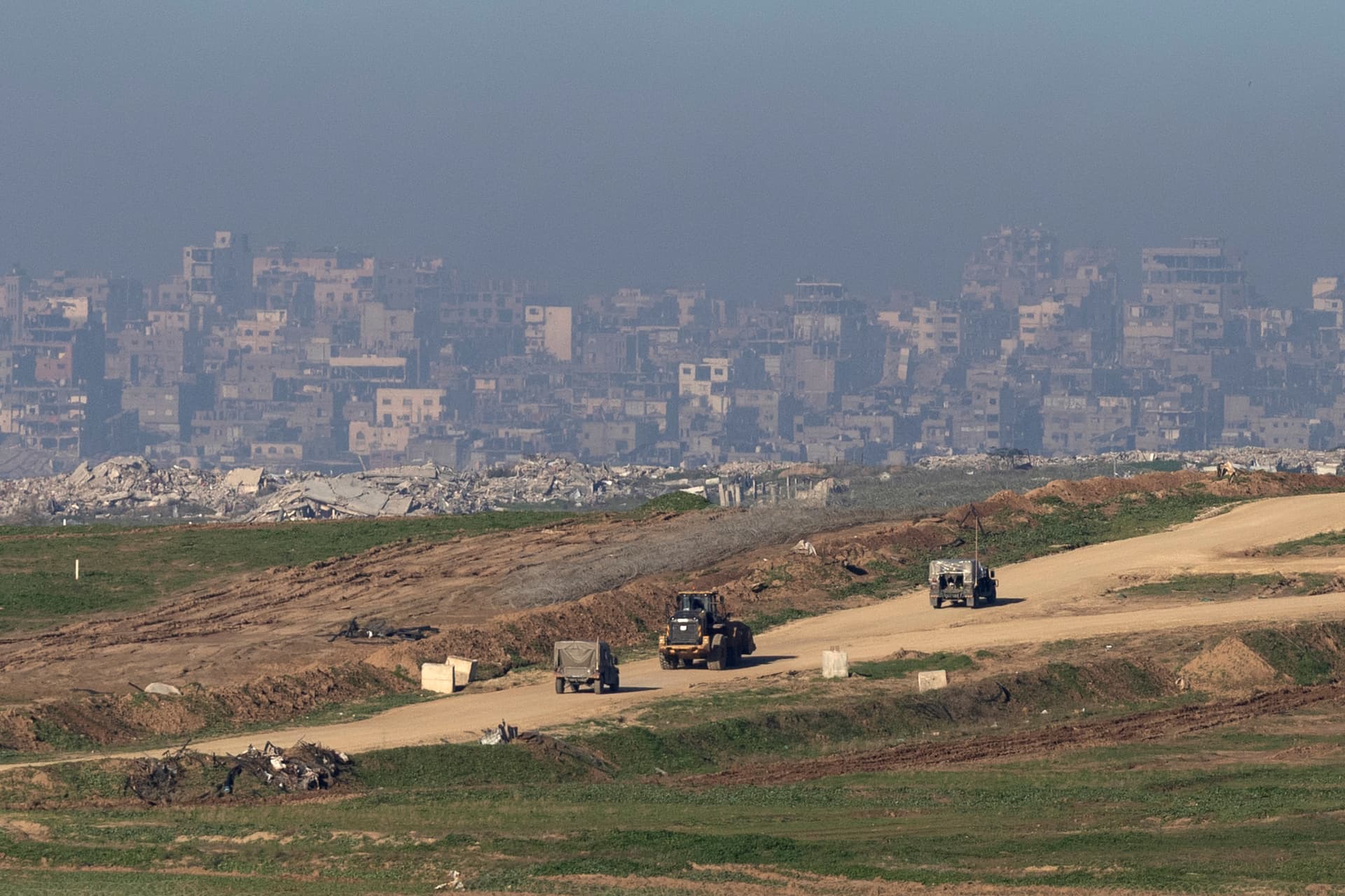 Israeli army vehicles and a tractor move in the northern Gaza on January 16, 2026.