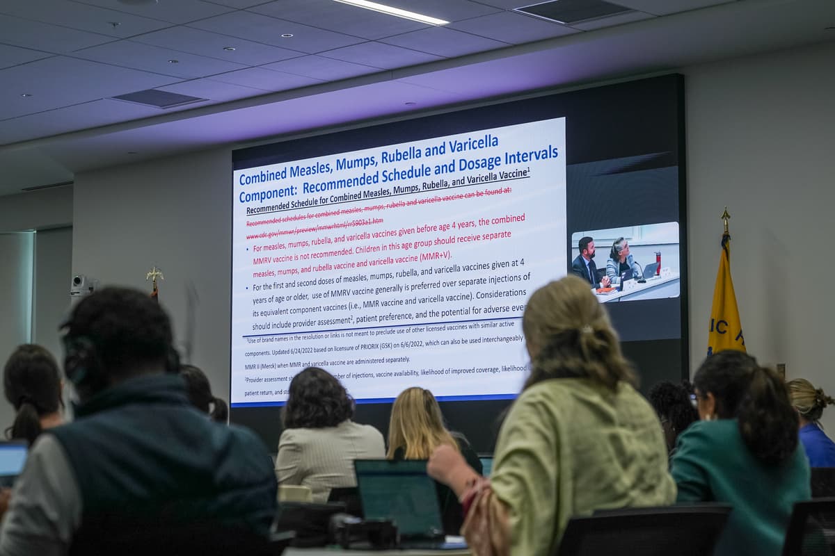 A slide showing the changes proposed by the CDC's Advisory Committee on Immunization Practices to the MMR combination vaccine schedule and dosage intervals is seen during a meeting of the CDC's Advisory Committee on Immunization Practices on September 18, 2025.