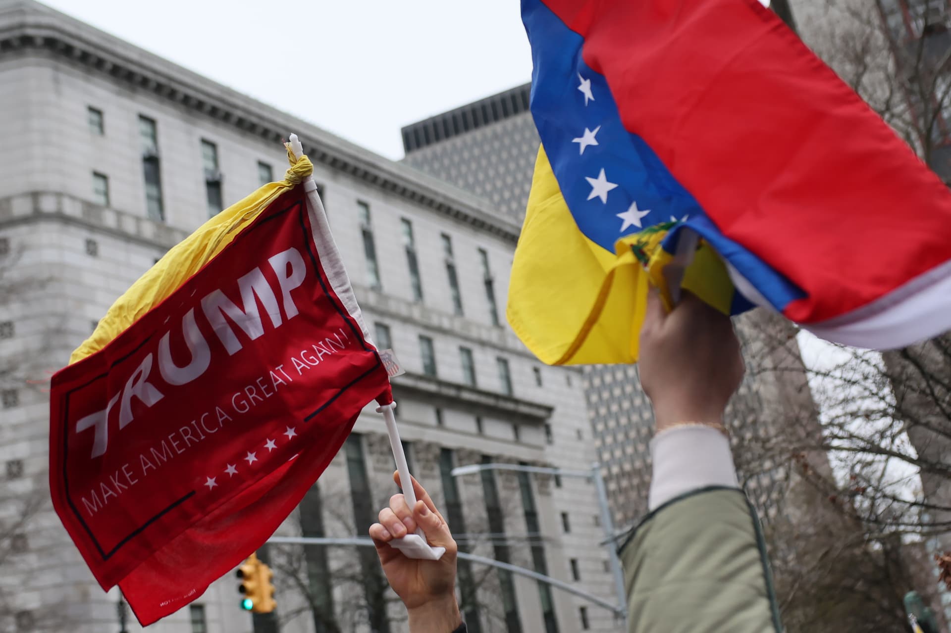 People hold Venezuelan flags outside of the Daniel Patrick Moynihan United States Courthouse before the arraignment of President of Venezuela Nicolas Maduro's and first lady Cilia Flores on January 05, 2026.