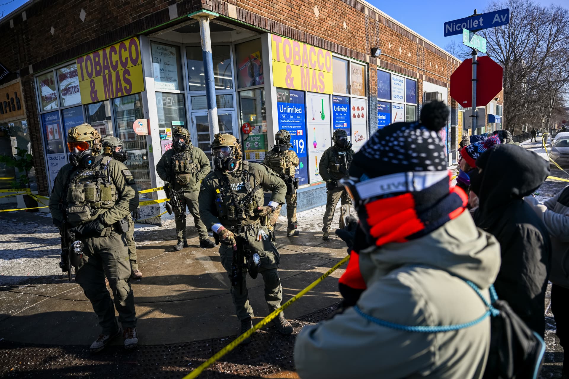 Onlookers gather after federal agents shot a protester at Minneapolis, Minnesota.