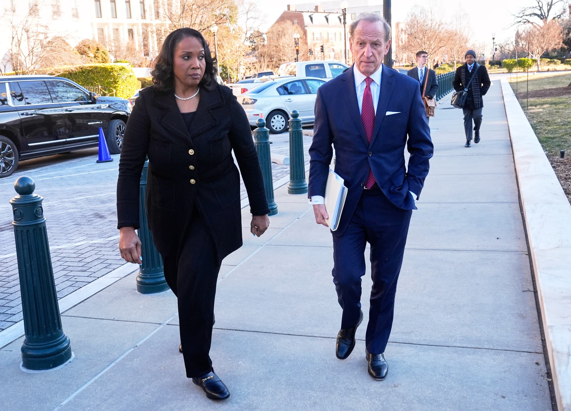 Federal Reserve governor Lisa Cook and attorney Abbe Lowell, arrive at the Supreme Court in Washington, Wednesday, Jan. 21, 2026.
