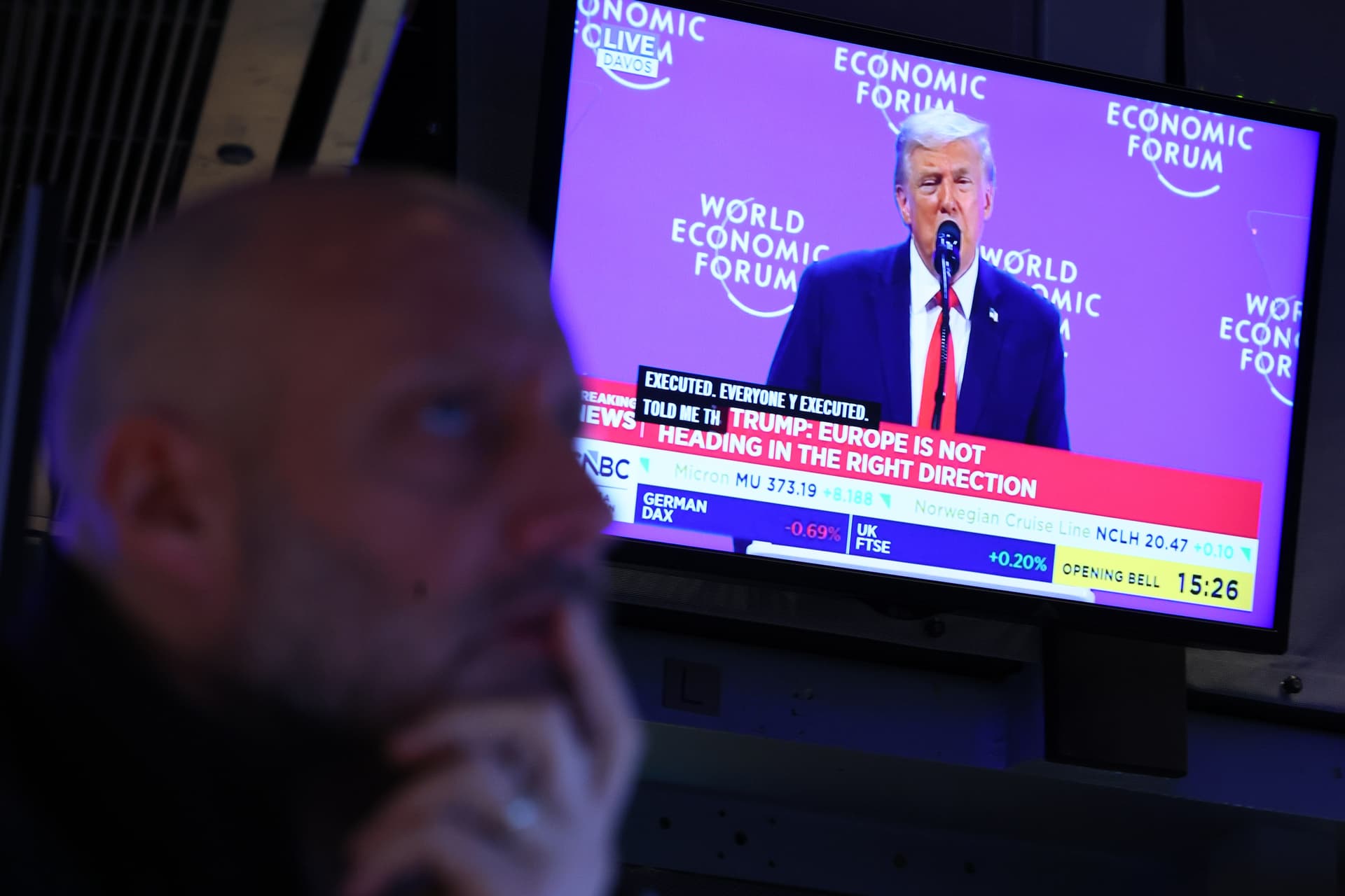 President Trump is seen speaking on a television as traders work on the floor of the New York Stock Exchange during morning trading on January 21, 2026 at New York City. 