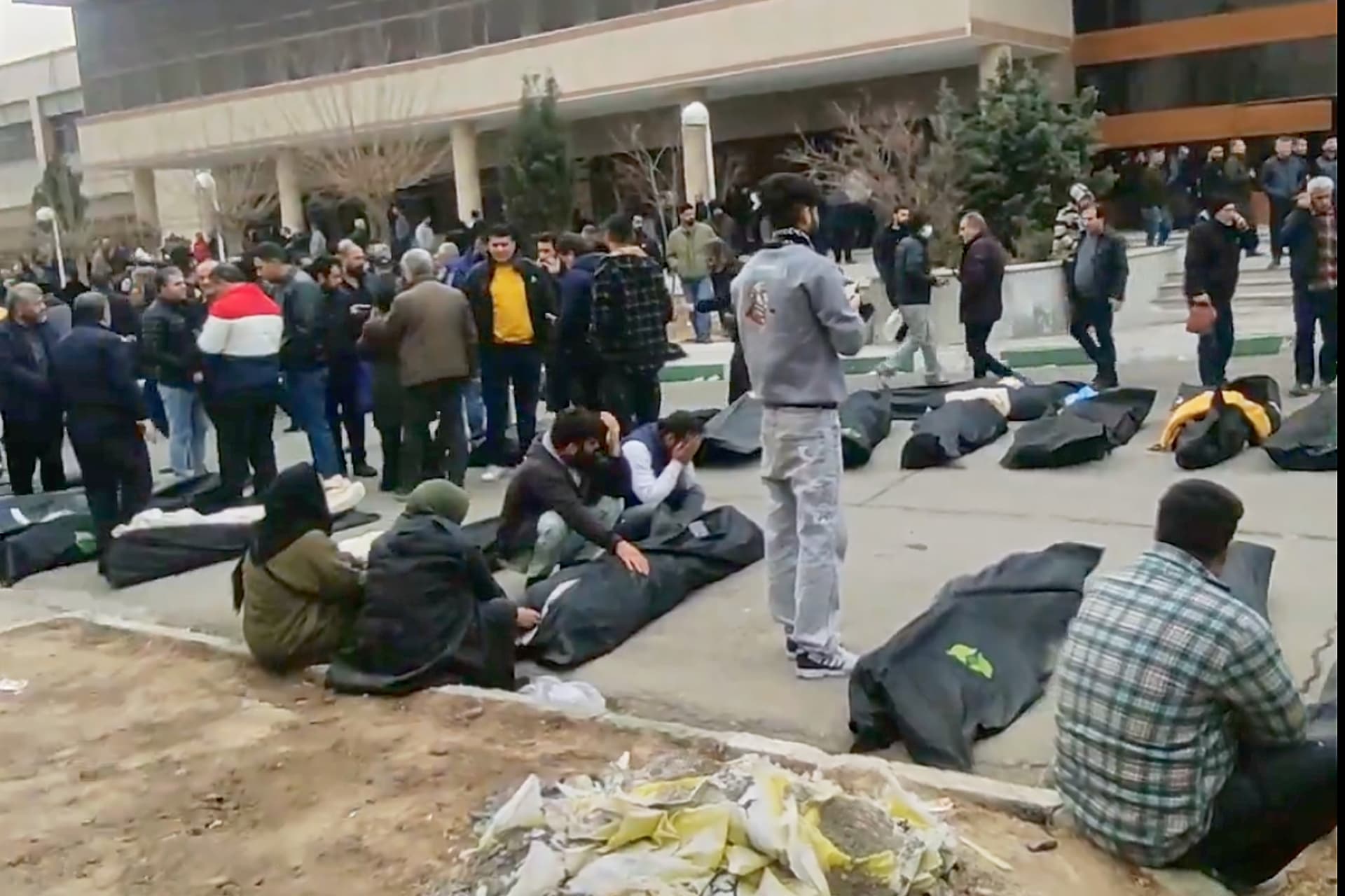 This frame grab from videos taken between January 9 and January 11, 2026, and circulating on social media shows images from a morgue with dozens of bodies and mourners after crackdown on the outskirts of Iran's capital.