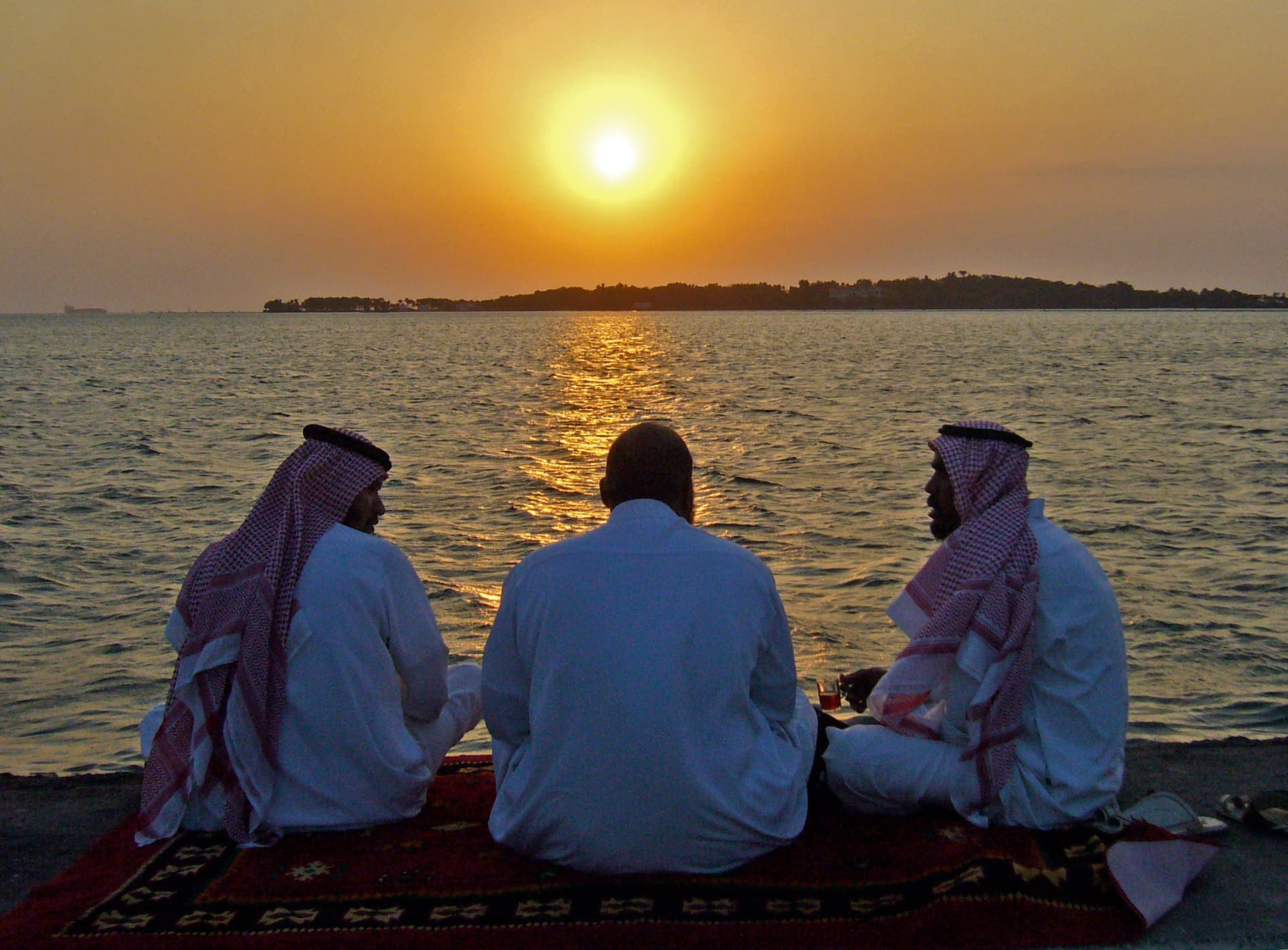 Saudi men watch the sunset on the waterfront at Jeddah.