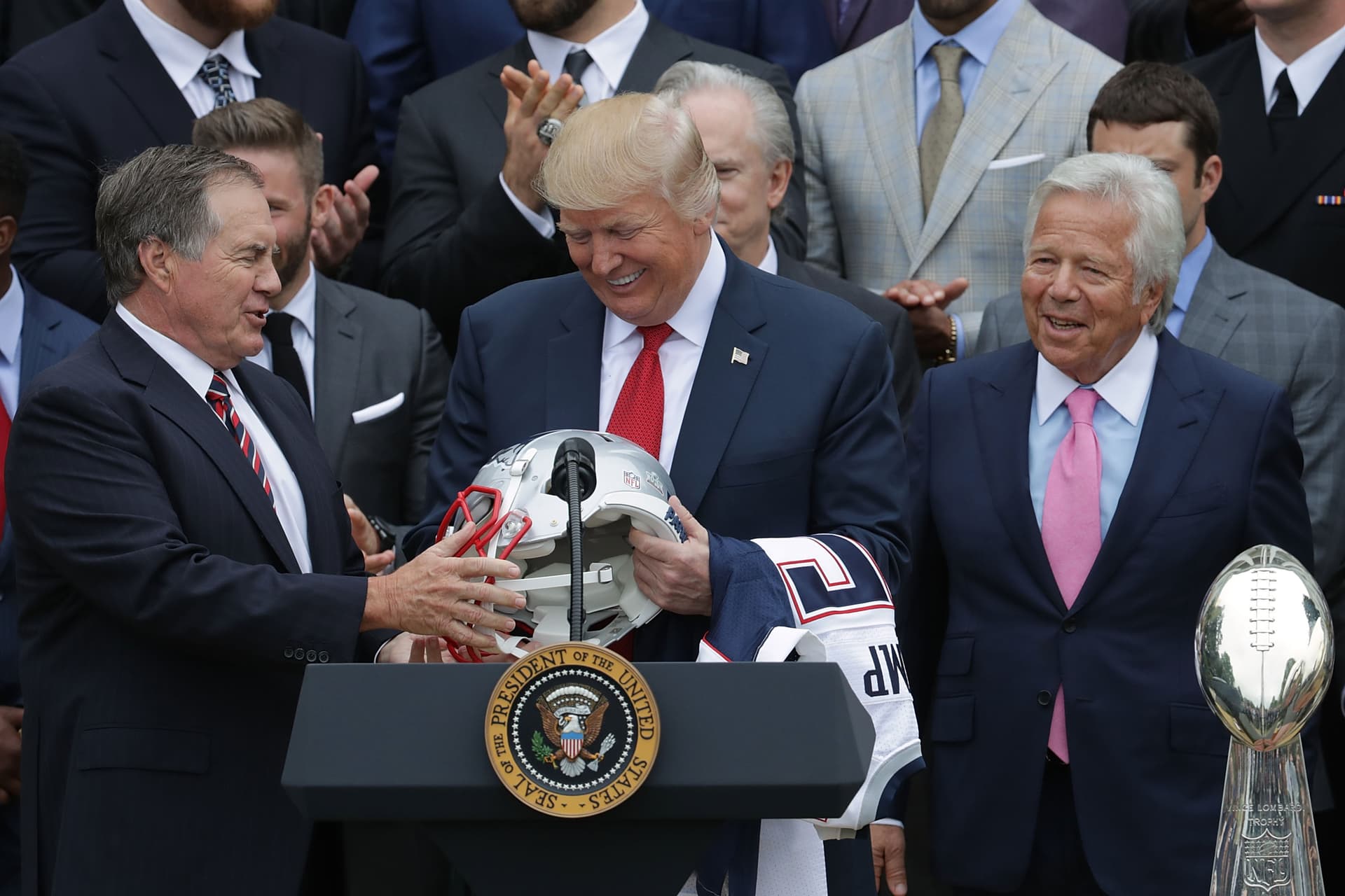 New England Patriots Head Coach Bill Belichick and team owner Robert Kraft present a football helmet to President Trump during a celebration of the team's Super Bowl victory on the South Lawn at the White House April 19, 2017.