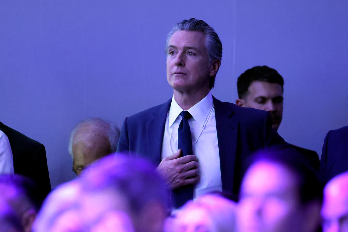 Governor Gavin Newsom watches as President Trump gives a speech at the World Economic Forum on January 21, 2026 at Davos, Switzerland.