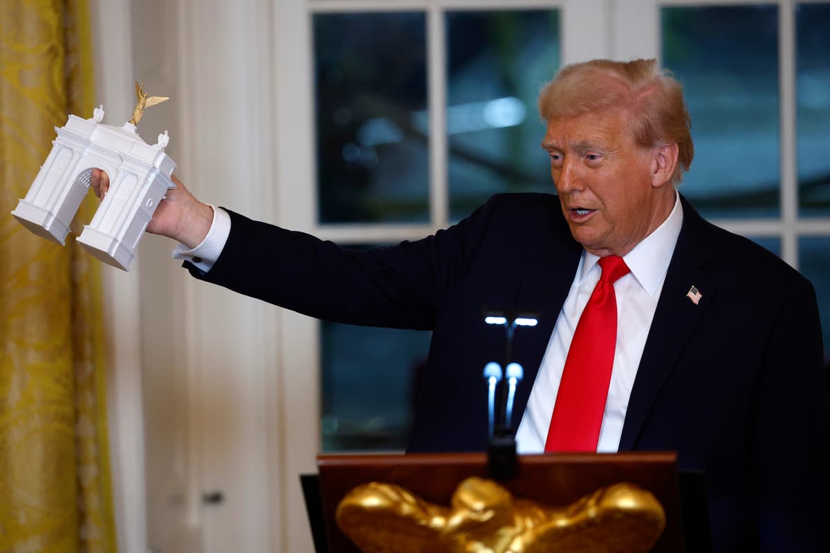 President Trump holds a model of an arch at the White House on October 15, 2025. 