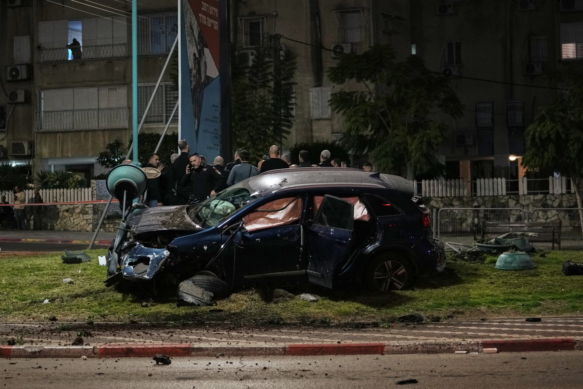 Israeli police investigate a deadly crime scene in the mixed Arab-Jewish town of Lod in central Israel, where a gunman fired on a car, killing one person and injuring two others, January 31, 2026. 