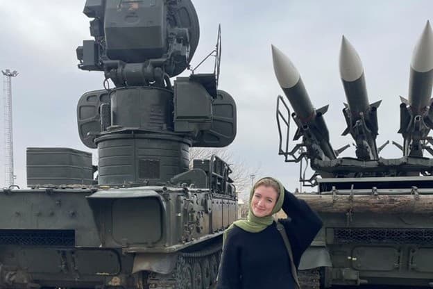 Calla Walsh poses in front of what she describes as Iranian missiles during her visit to Iran on February 13, 2026. 