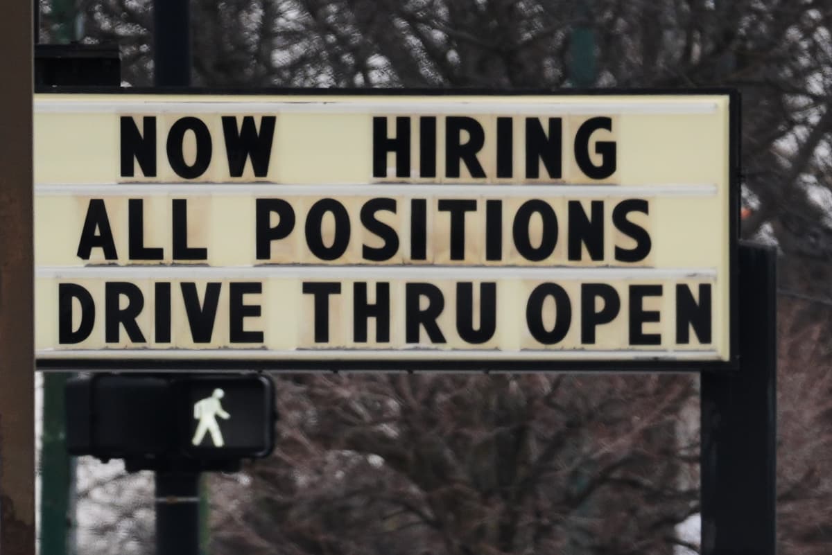A hiring sign is displayed in front of a restaurant at Chicago on February 5, 2026. 