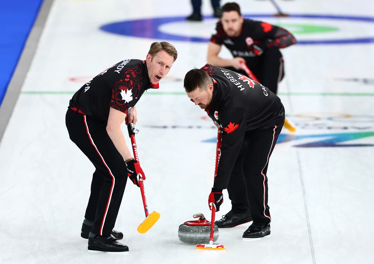 Marc Kennedy of Team Canada (left) competes in curling against Team United States during the 2026 Winter Olympics at Cortina d'Ampezzo, Italy, on February 13, 2026.