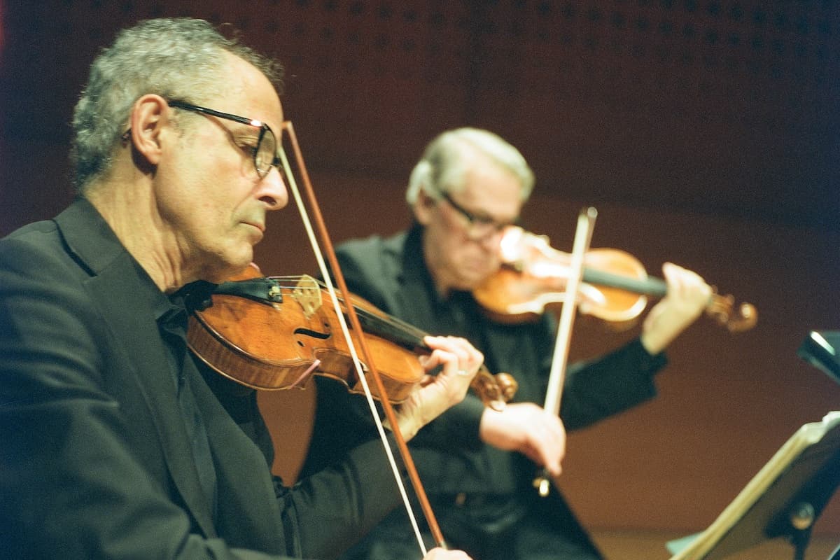 Violinists Eugene Drucker and Philip Setzer in a scene from ‘Four Rational People.’ 