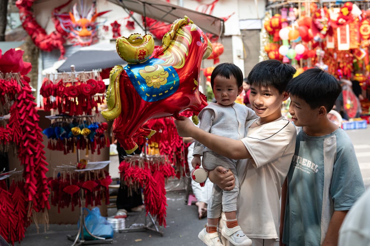 People shop for decorations along a street ahead of the Lunar New Year, welcoming the Year of the Fire Horse on February 16, 2026 at Hanoi, Vietnam. 